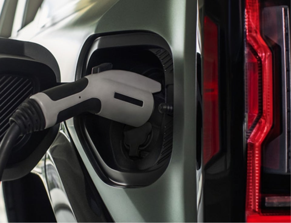 Close up of charging port with charger plugged in on a GMC Hummer EV SUV - Coughlin London GMC in London OH